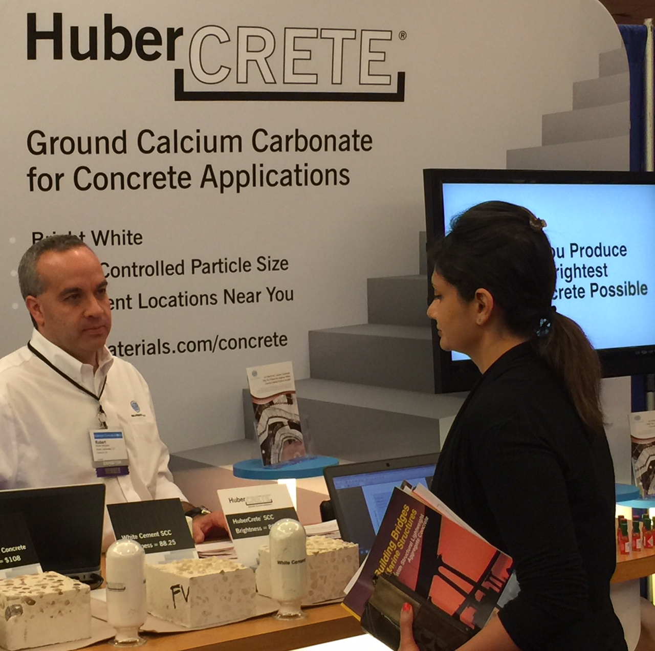 Huber's Bobby Bergman (left) explains the many benefits of HuberCrete® ground calcium carbonate with an attendee at the American Concrete Institute's (ACI) Fall Convention and Expo.