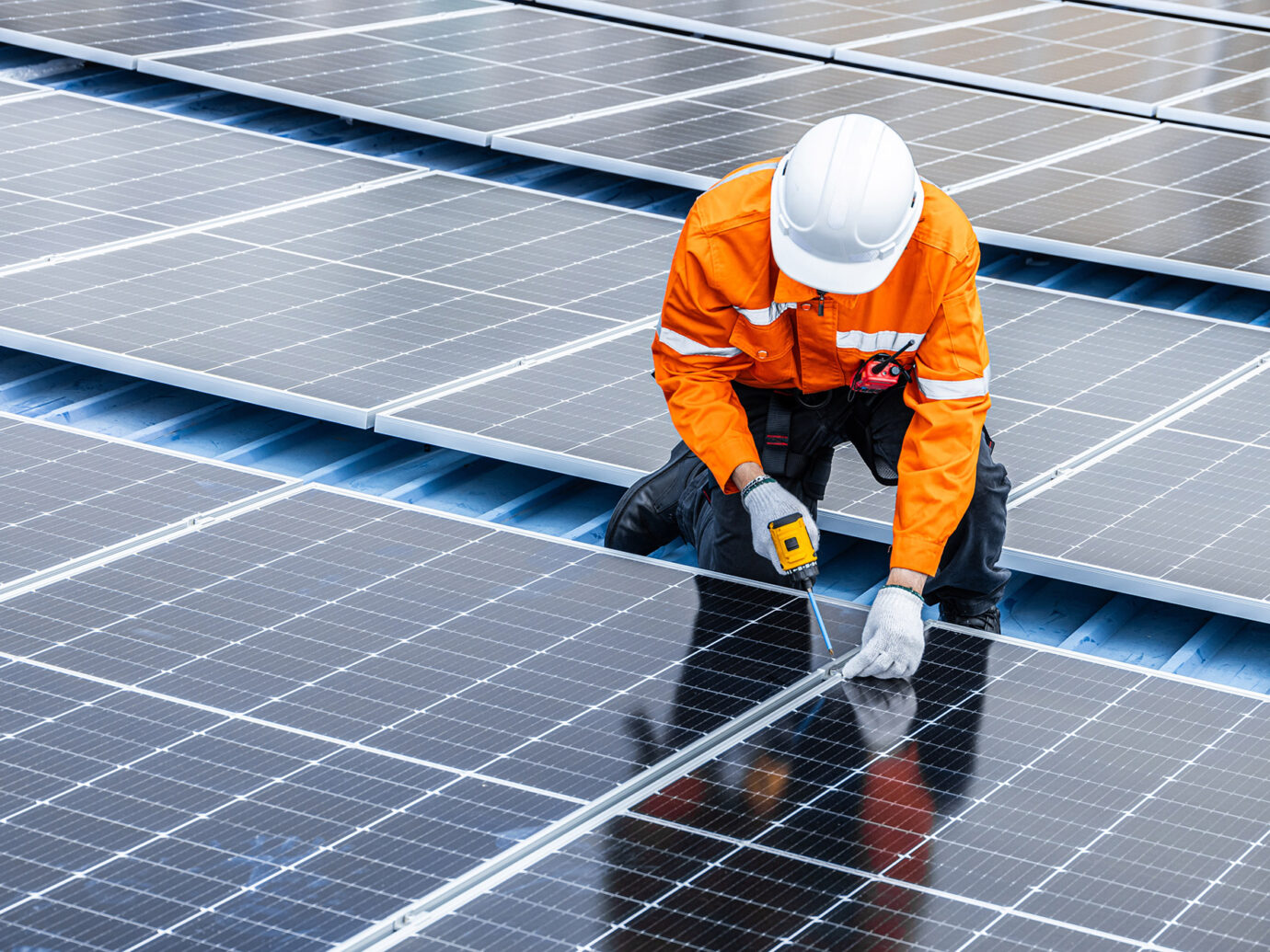 man working on solar panels